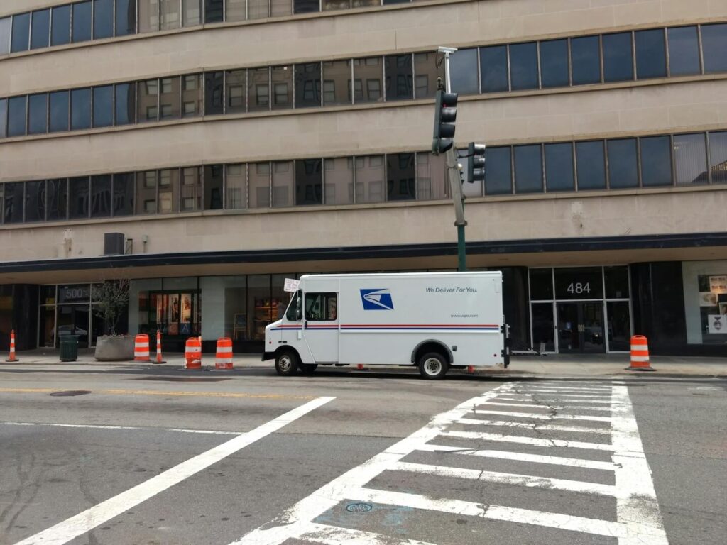 USPS truck delivering to business